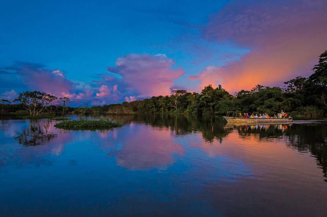 A skiff on the Amazon River at dawn
